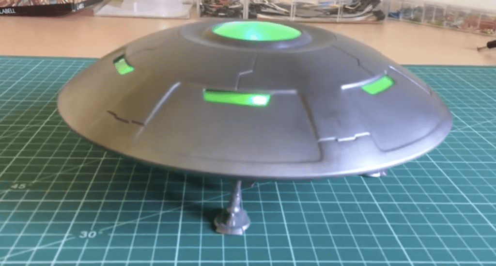 saucer UFO model with green LED lighting on the inside