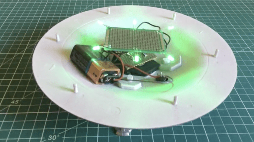 Bottom half of UFO model with LEDs, and Stripboard holding Arduino nano, plus wires and 9-volt battery